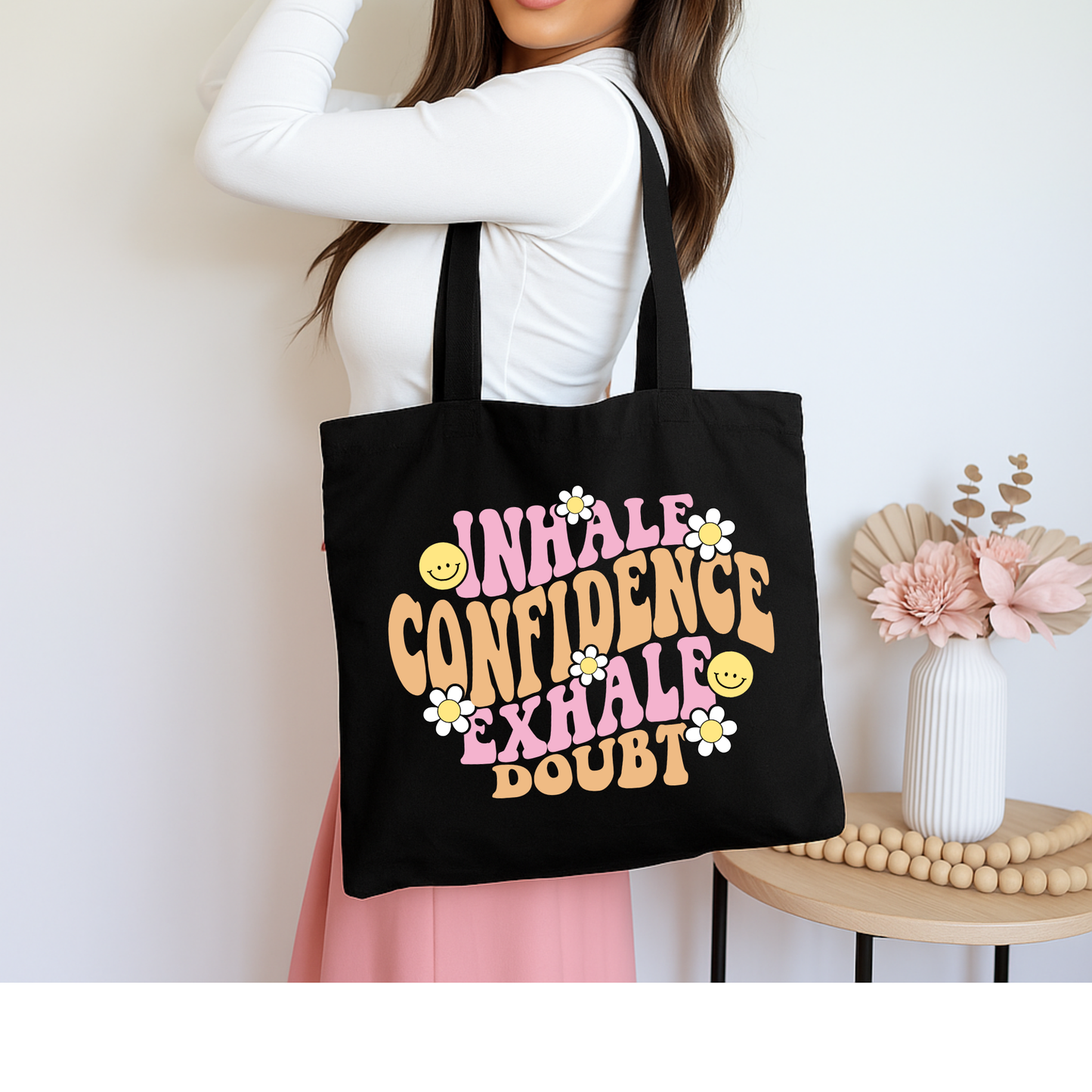 Black tote bag with retro quote “Inhale Confidence, Exhale Doubt” in groovy font