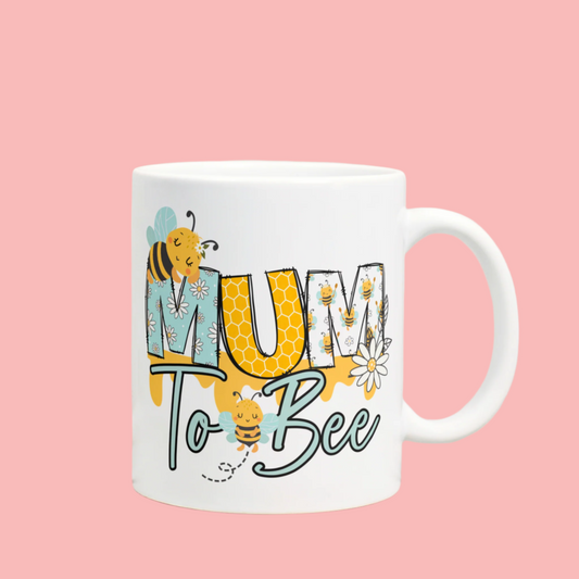 Cute bee-themed ‘Mum to Bee’ 11oz mug, perfect gift for expecting mothers, featuring a playful and colourful design.