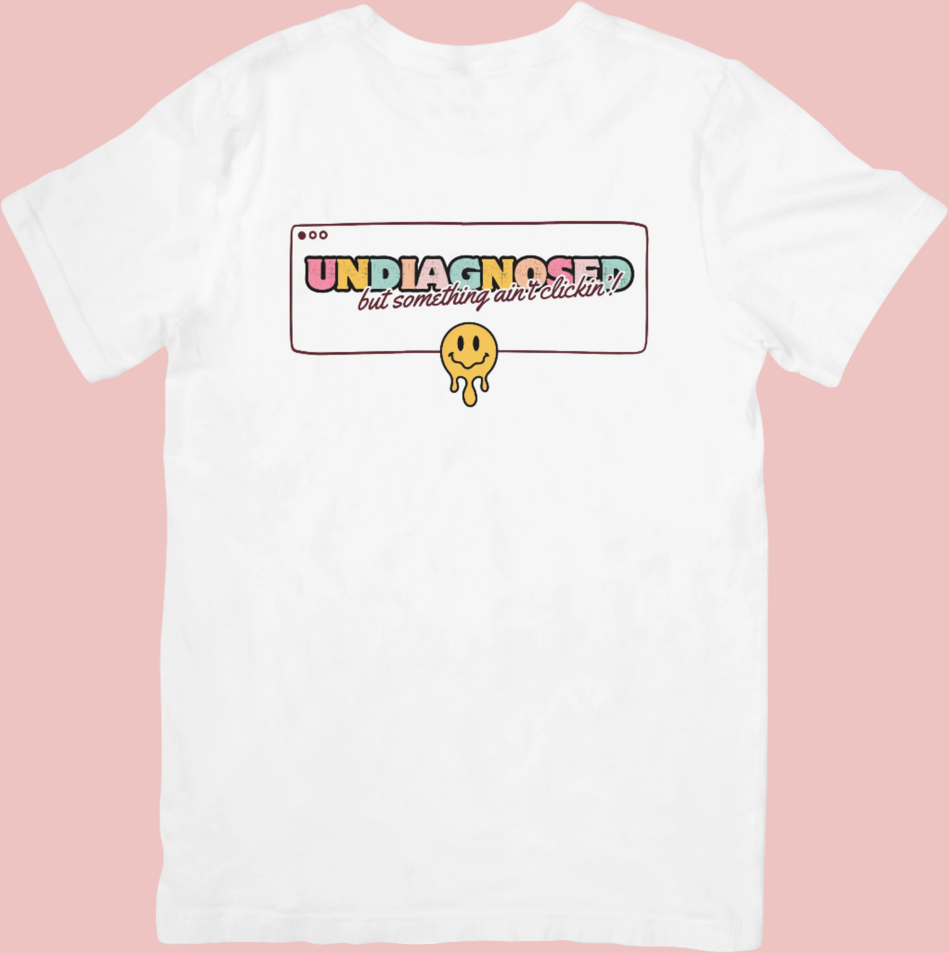 Retro-style crew neck t-shirt with a smiley face design and the phrase ‘Undiagnosed: But The Math Ain’t Mathin’,’ celebrating neurodivergence and embracing the journey.