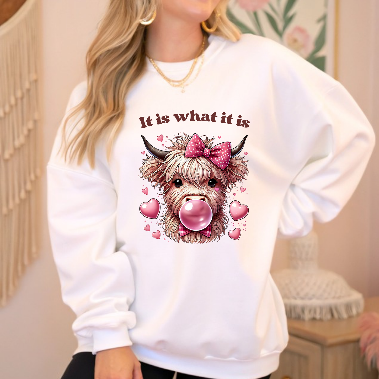 White sweatshirt with highland cow blowing bubblegum and pink bow
